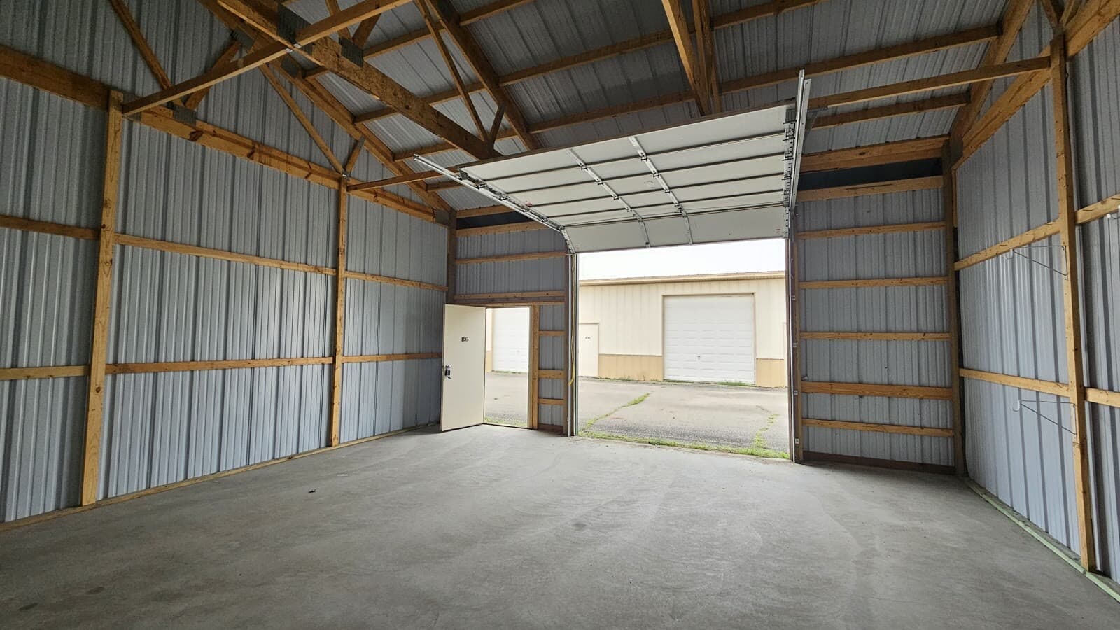 Storage unit interior showing concrete floor and metal walls